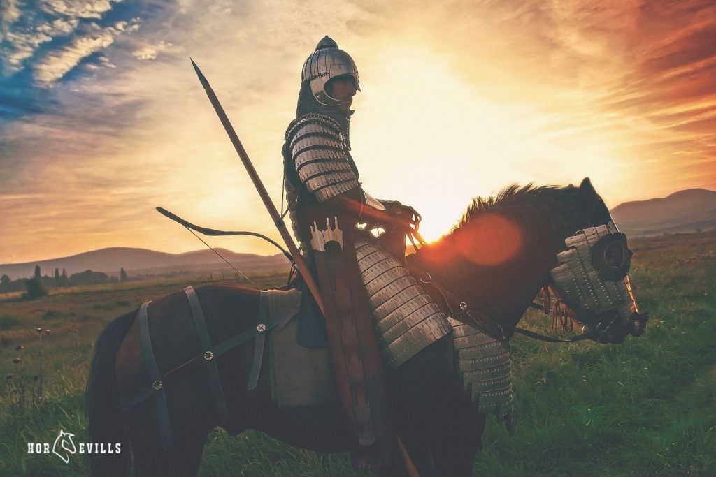 A knight on a horse during a sunset
