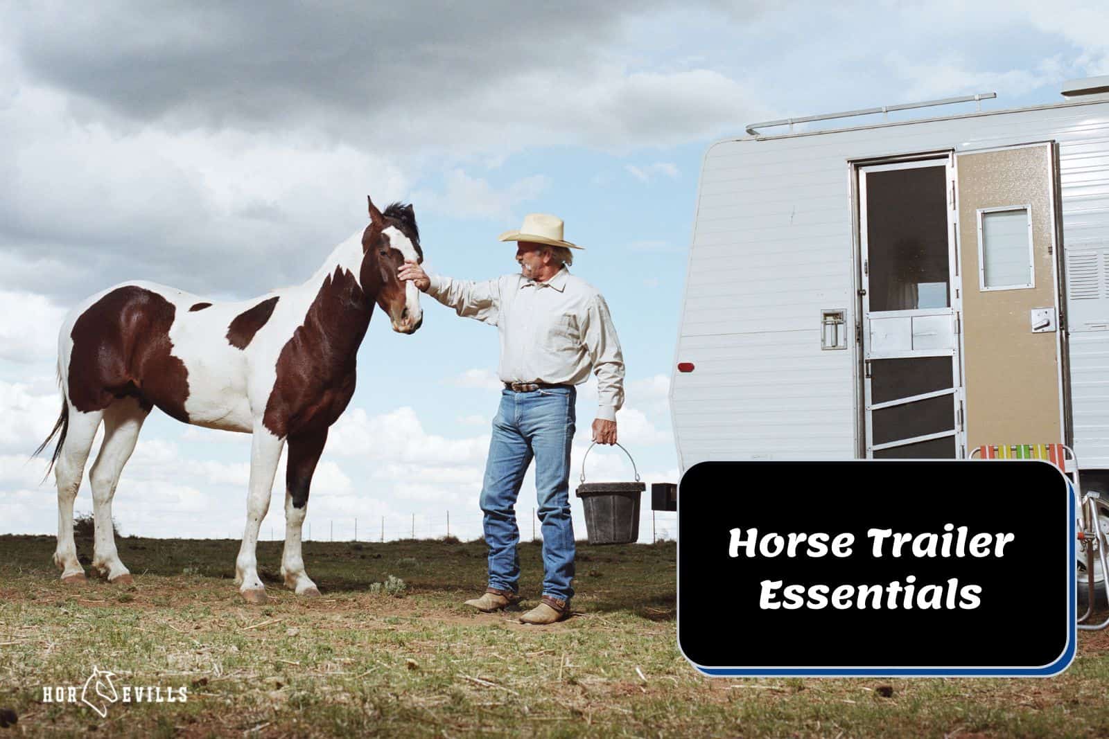 cowboy petting a horse beside a trailer (horse trailer essentials)