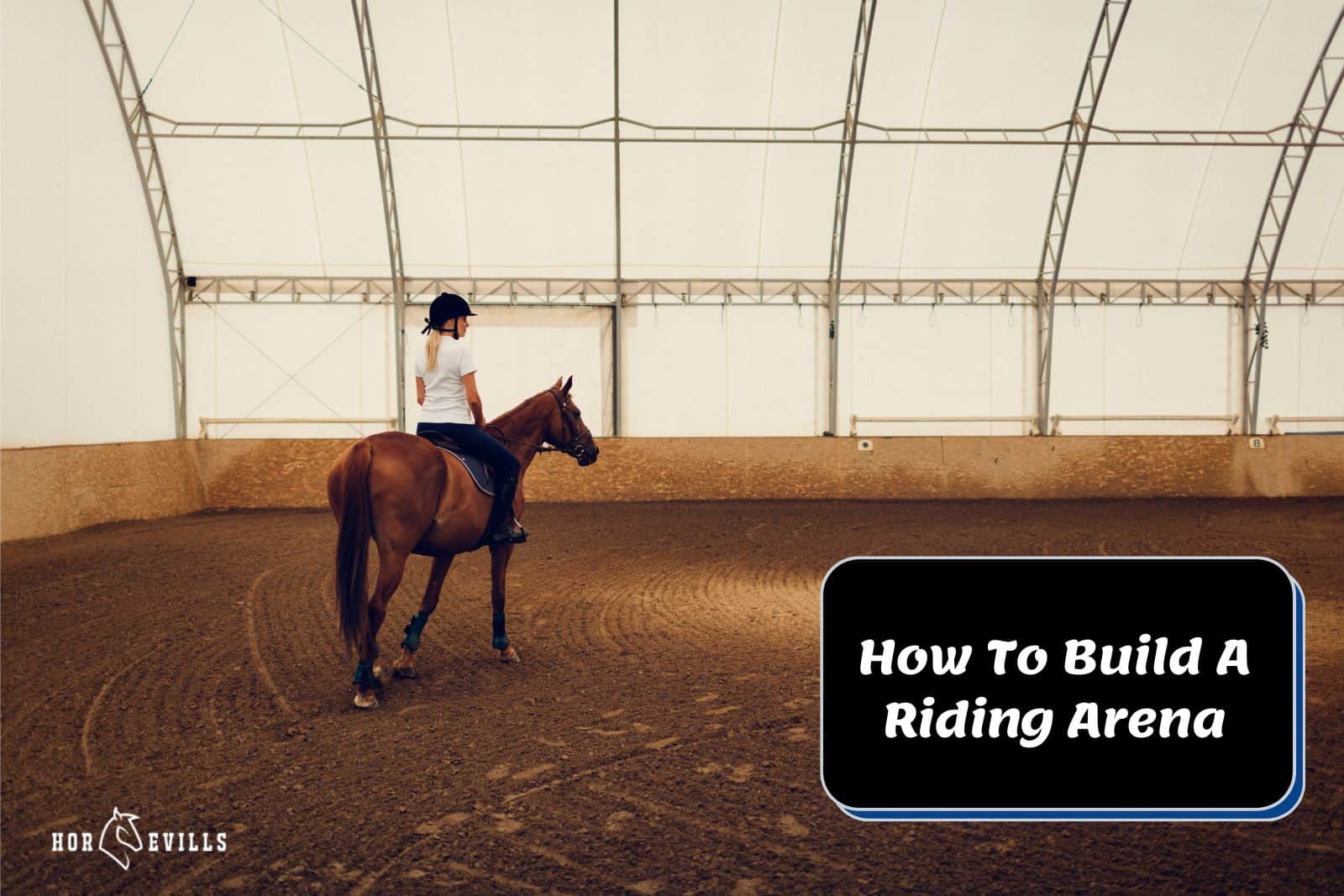 lady riding a horse in the indoor arena but how to build a riding arena?